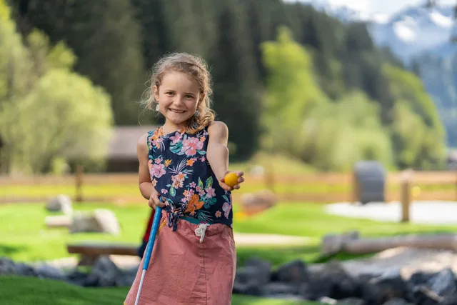 Kind mit Minigolfball und Schläger