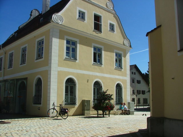 Altes Rathaus in Marktoberdorf mit gelber Fassade und geschwungenem Giebel