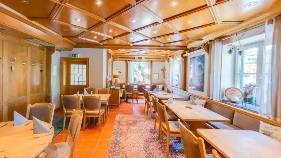 Holzgetäfelter Gastraum des Restaurant Kurfürst mit gedeckten Tischen und Sitzbänken