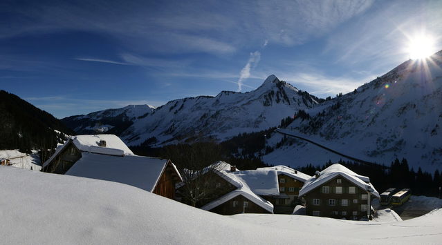 Verschneite Häuser und Berglandschaft bei Damüls