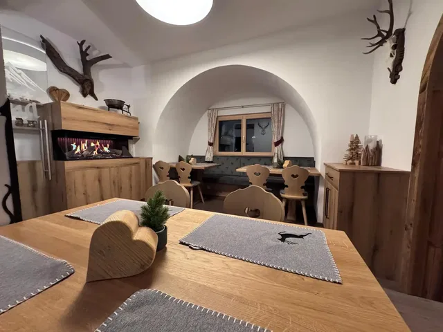 Gastraum des Posthansl mit Holzmöbeln und Kamin