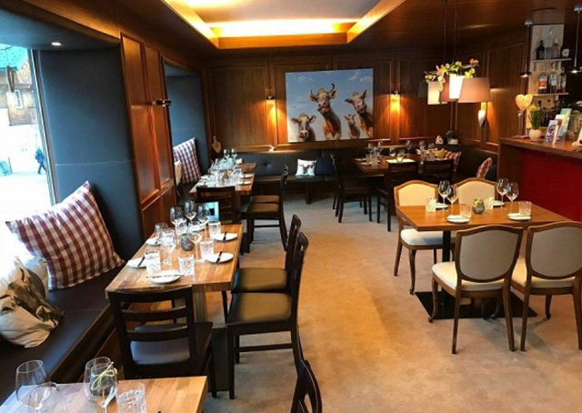 Gastraum der Uusziit mit Holztischen und Weinbar