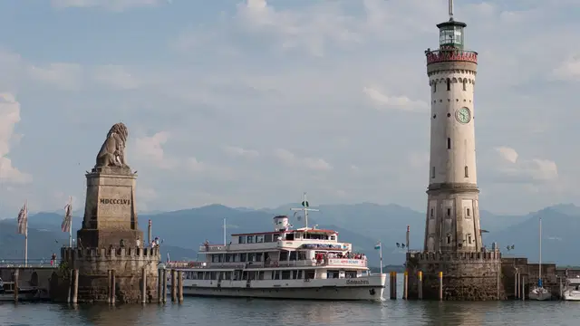 Bayerischer Löwe und Neuer Leuchtturm an der Lindauer Hafeneinfahrt mit dem Schiff Schwaben. Ortsmotiv.