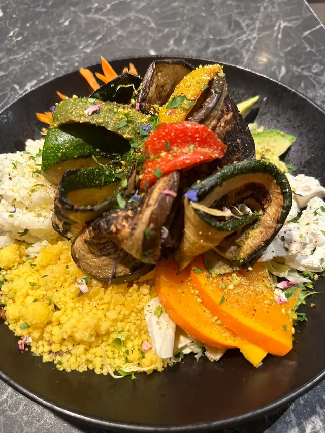 Gegrilltes Gemüse auf Couscous, bunte Paprika- und Zucchini-Scheiben