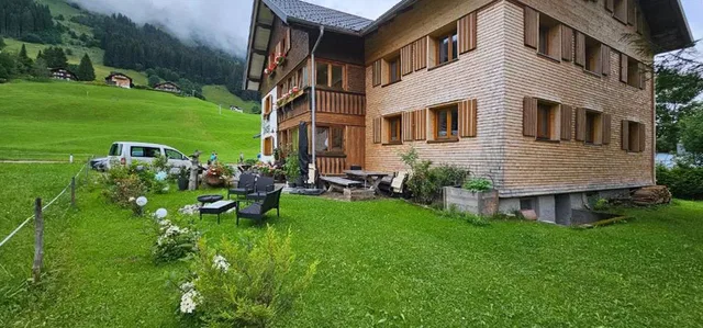 Sommerliche Hausansicht der Ferienwohnungen Zunzer mit Garten