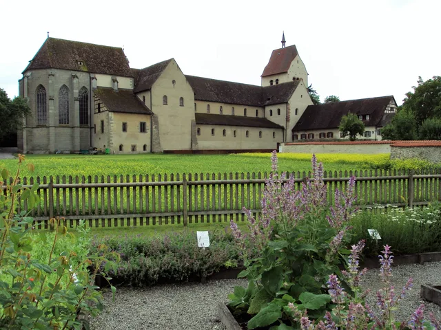 Historische Klosteranlage am Bodensee mit Garten, Holzzaun und Lavendel im Vordergrund.
